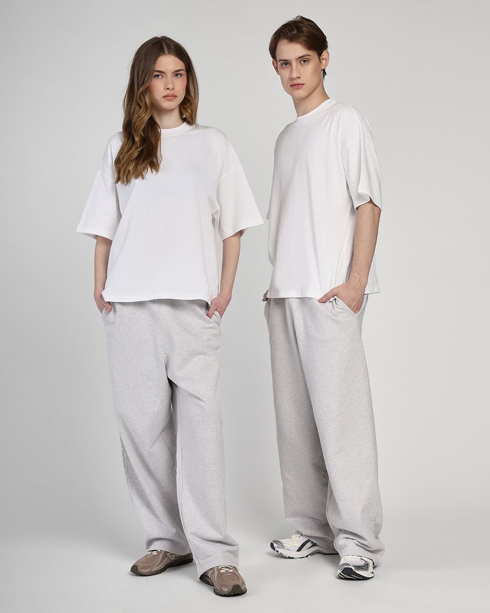 Two models in light grey co-ordinated sets on a neutral studio backdrop