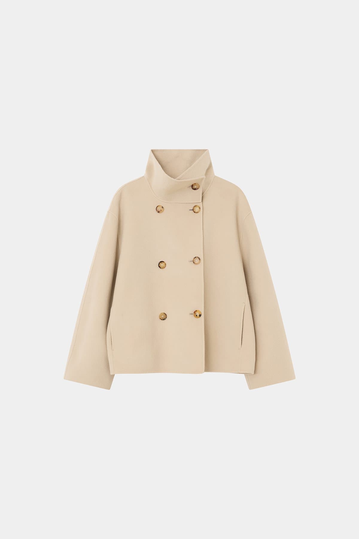 Beige double-breasted short coat photographed on a light background
